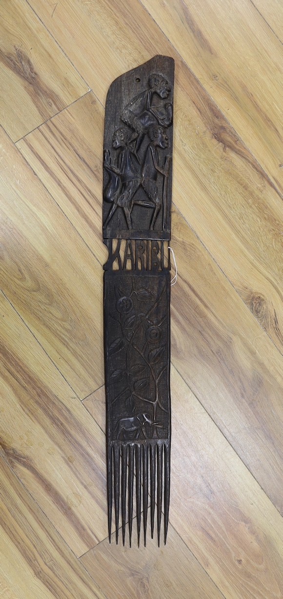 An African carved hardwood comb, Swahili, 83 cms long.